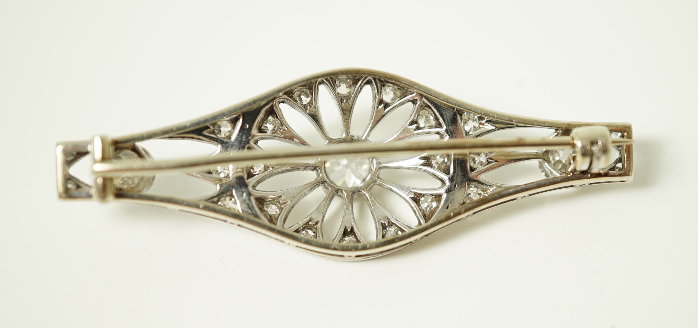 A 1920's pierced white gold and diamond cluster set brooch
